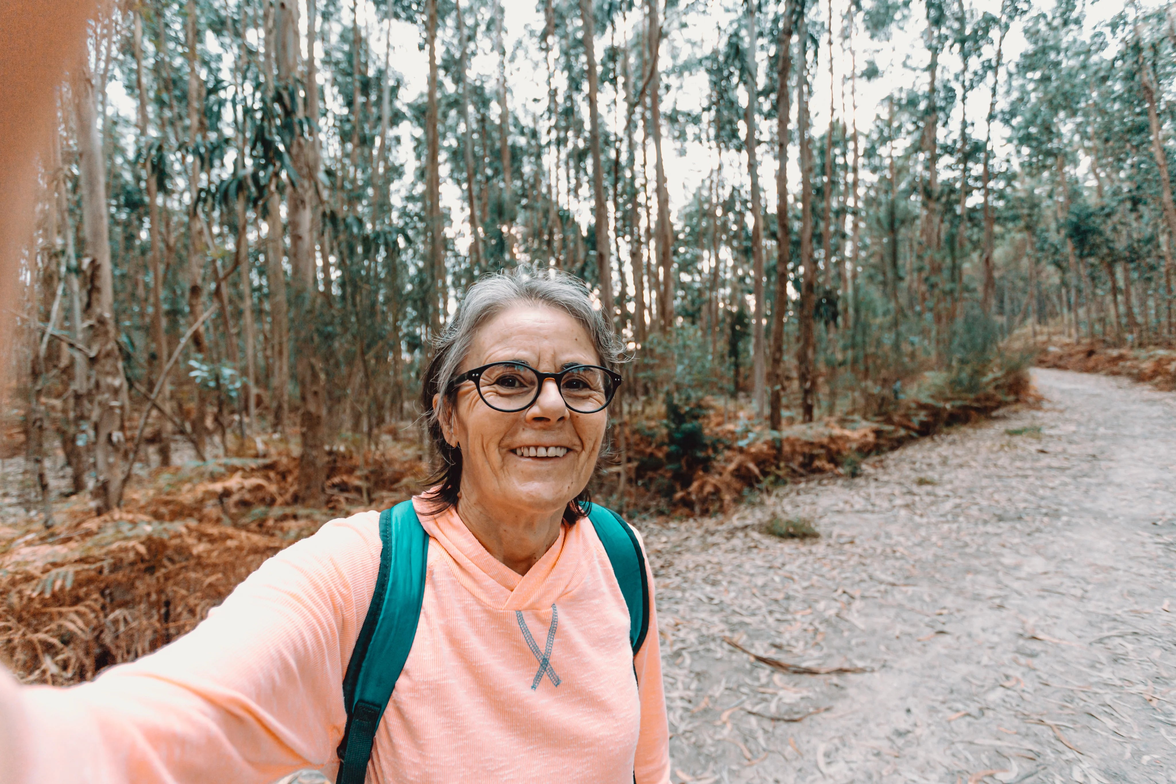 files/woman-smiles-and-takes-a-selfie-while-out-on-a-hike_1.webp